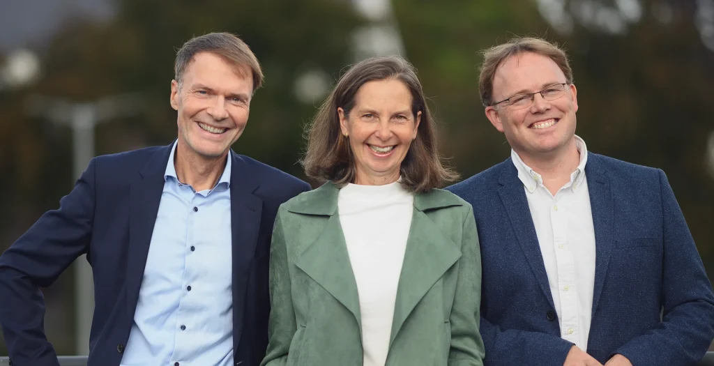 Three team members of Lutze Attorneys standing outdoors.